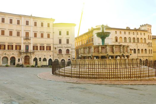 Perugia city with Piazza IV Novembre square with monumental fountain Fontana Maggiore at sunrise, Umbria, Italy.