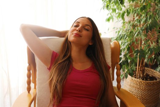 Young woman relaxed at home with closed eyes