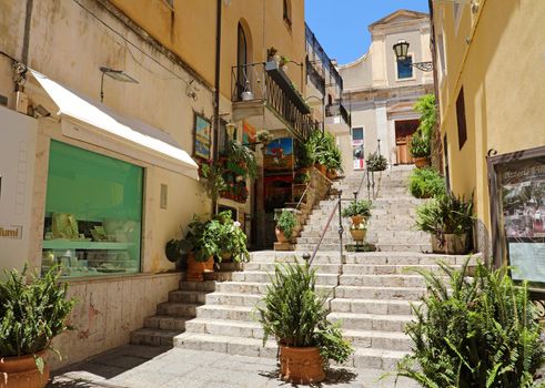 TAORMINA, ITALY - JUNE 20, 2019: cozy flight of steps with plants in Taormina, Sicily