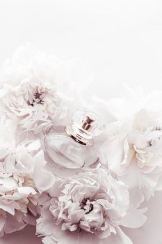 Chic fragrance bottle as luxe perfume product on background of peony flowers, parfum ad and beauty branding