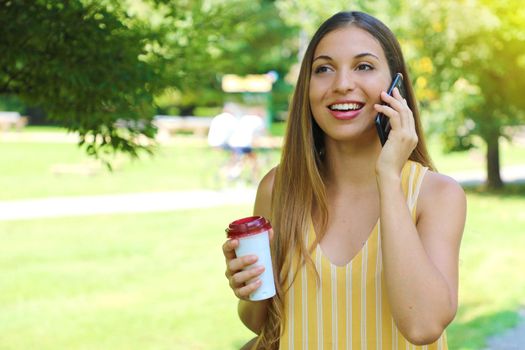 Portrait of young business woman calling with smart phone outdoor.