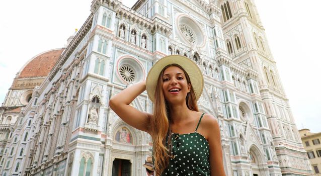 Pretty young tourist woman with Florence Cathedral on background. Traveler girl in Italy.