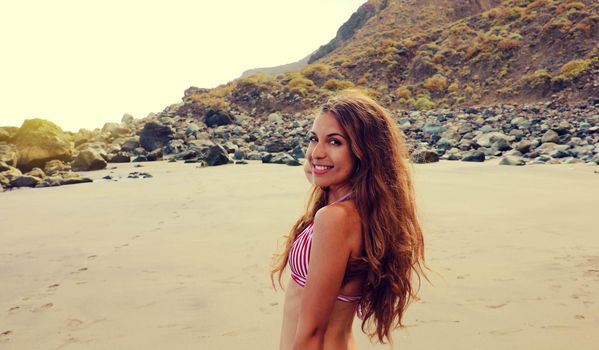 Sexy tanned bikini woman on Playa de Benijo, Tenerife