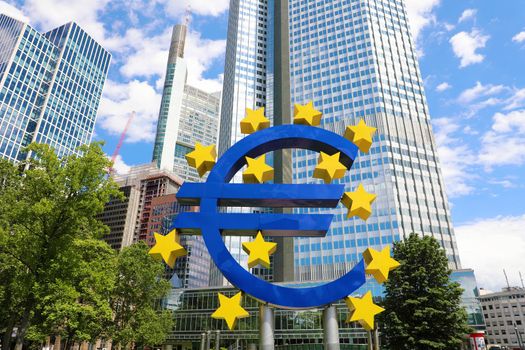 Business and finance concept with giant Euro sign at European Central Bank headquarters in the morning, business district in Frankfurt am Main, Germany