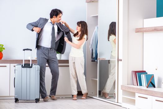 Wife seeing her husband off to business trip