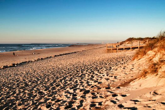 Beautiful beach with dunes and wooden walkway in Aveiro