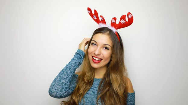 Christmas woman with reindeer horns smiling happy on white background