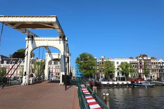 AMSTERDAM, NETHERLANDS - JUNE 6, 2018: bridge Magere Brug (Skinny bridge) on Amstel river, Amsterdam, Netherlands