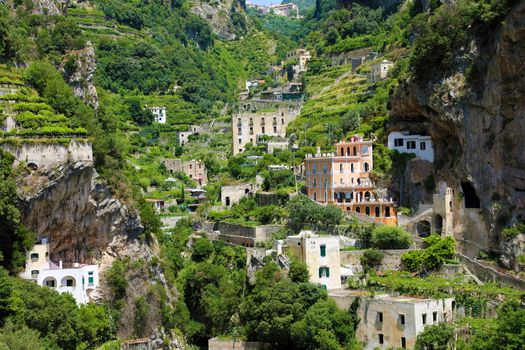 Scattered houses on rocky mountains in the nature with vineyards in Atrani village, Amalfi Coast, Italy