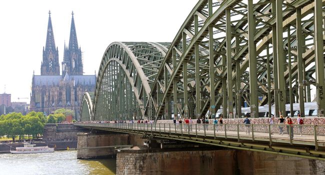 COLOGNE, GERMANY - MAY 31, 2018: people enjoy to walk along the promenade at the Hohenzollern bridge in Cologne, Germany