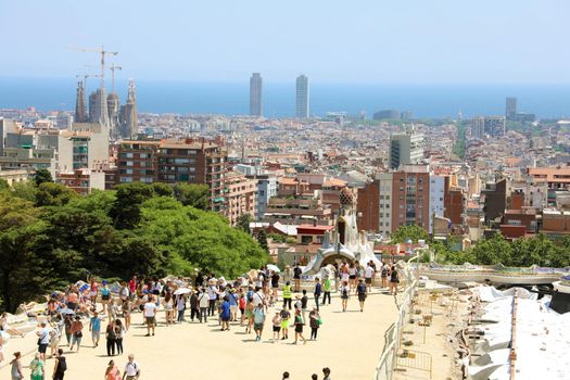 BARCELONA, SPAIN - JULY 12, 2018: cityscape of Barcelona from Park Guell with tourists, Barcelona, Spain