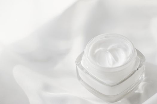 Face cream moisturizer jar on silk background, moisturizing skin care lotion and lifting emulsion, anti-age cosmetics for luxury beauty skincare brand