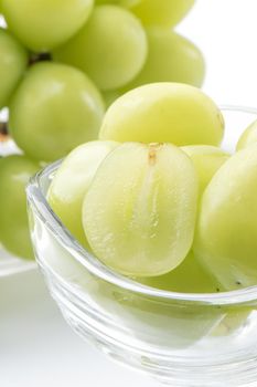 Beautiful Shine Muscat green grape in a glass cup isolated on white background.