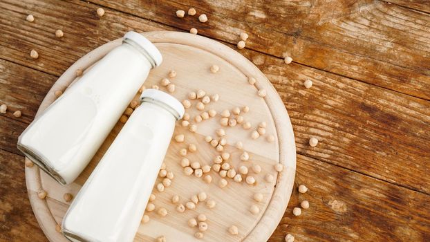 Soy milk and soy bean it on wooden background, healthy concept.