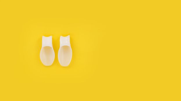 White silicone finger divider on a yellow background