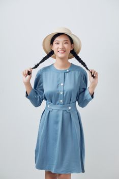 Beautiful young asian woman with straw hat. Her hair is tied in two big ponytails. 