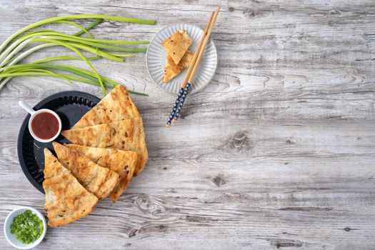 Taiwanese delicious scallion pancake over wooden table background