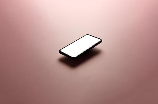 Minimalistic mock up flat image design with a floating mobile phone with copy space and white scree to write over it over a flat pastel pink background