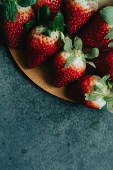 Some strawberries over a wooden plank with delicious aspect