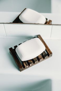 A hard soap over a soap dish in a white toilet
