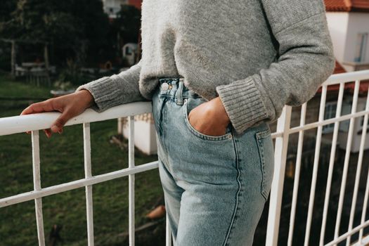 Close up of a woman wearing mom jeans with copy space during a bright day, fashion and styling concept