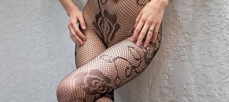 Naked woman in fishnet tights