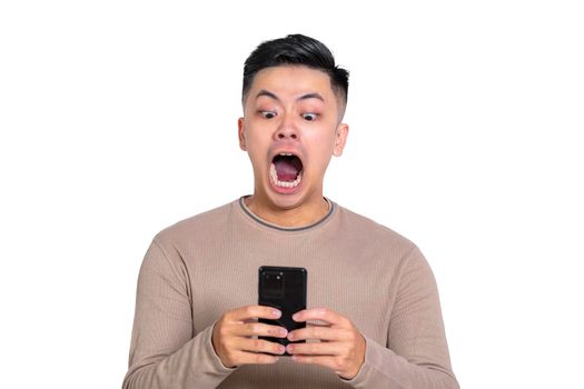 Shocked and scary face of Asian man watching the smartphone