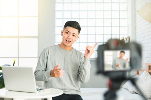 Young man recording video for an internet tv show or tutorial streaming