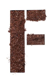 stencil letter F made above dirt on white surface