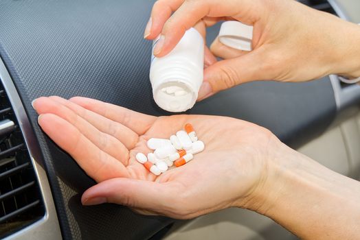 Women in car anti stress take pills. Women taking tablets inside his car from hard attack.