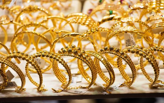 Display of dozens of golden bracelets in Turkish style