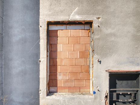 Bolted windows and a walled door on the facade of building