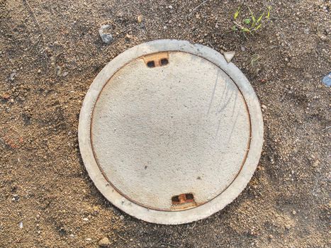 Manhole with the concrete cover on basement