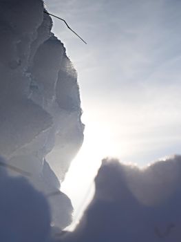 Dark ice hole with sun flares. Nature art 