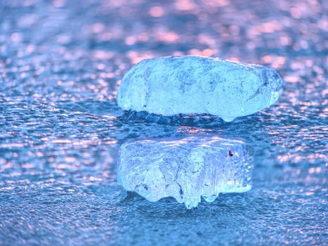 Natural winter icy background of defocused ice with copy space. Blue purple colors