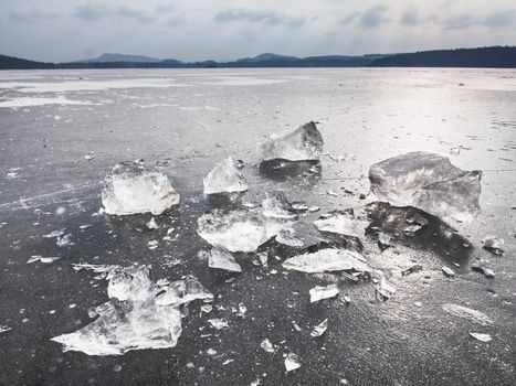 Ice fragments on frozen lake water level. The ice broken 