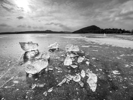 Ice fragments on frozen lake water level. The ice broken 