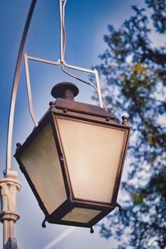 Old gas street lamp against the sky, vintage city lighting