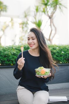 Beautiful healthy woman eating salad, Dieting Concept. Healthy Lifestyle.