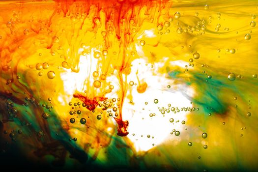 Paint dissolve swirling in water forming colorful background