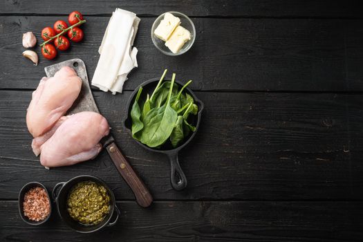 Preparation of chicken kiev from chicken breast stuffed with herbs, on black wooden table background, top view flat lay, with copy space for text