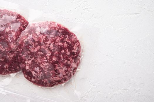 Burger meat vacuum sealed ready for sous vide cooking, on white stone background, top view flat lay, with copy space for text