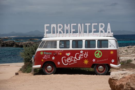 Classic German Volkswagen Transporter van on Es Pujols beach in Formentera in the summer of 2021
