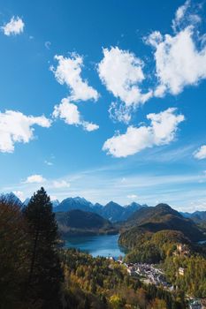 Beautiful nature of European Alps, landscape view of alpine mountains, lake and village on a sunny day, travel and destination