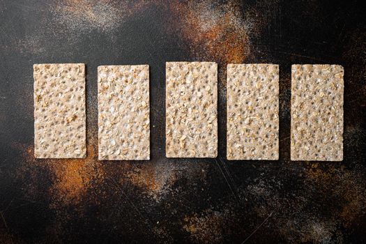 Grain diet light crisp bread , on old dark rustic table background, top view flat lay, with copy space for text