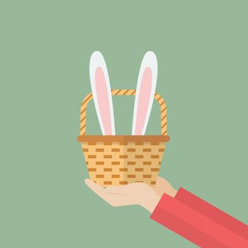Hand holding basket with bunny ears