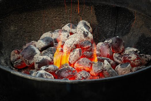 Hot charcoal in a round barbecue grill.