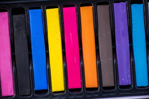 Crayons of various color in a box