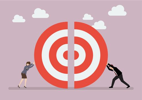 Businessman and woman pushing a pieces of big target together
