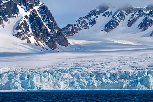 Deep Blue Glacier and Snowcapped Mountains, Arctic, Svalbard, Norway